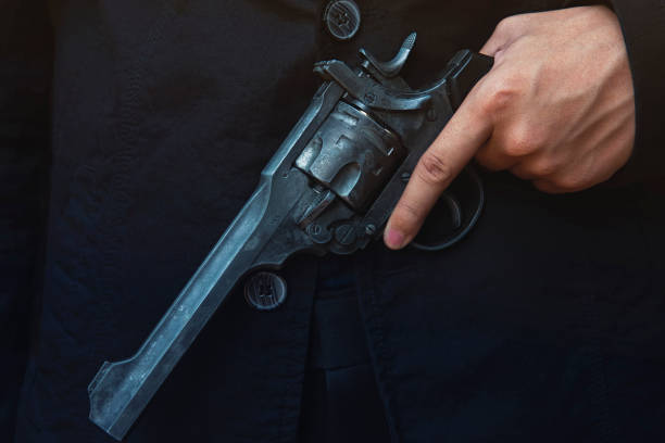 istock Close up man holding hand on a gun 1140351684