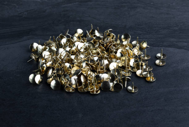 istock Heap of Drawing Pins on Slate Background 1140351701
