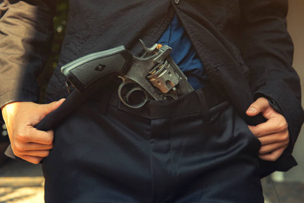 istock Close up man holding hand on a gun 1140351785