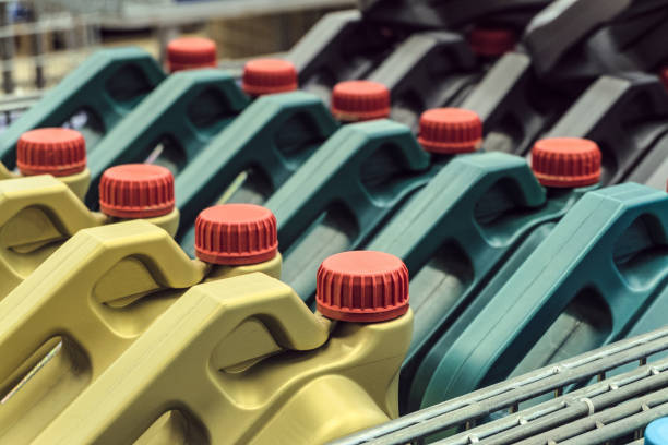 istock Colored plastic cans with engine oil. Rows of canisters placed on a pallet. Limited depth of field. 1140351940