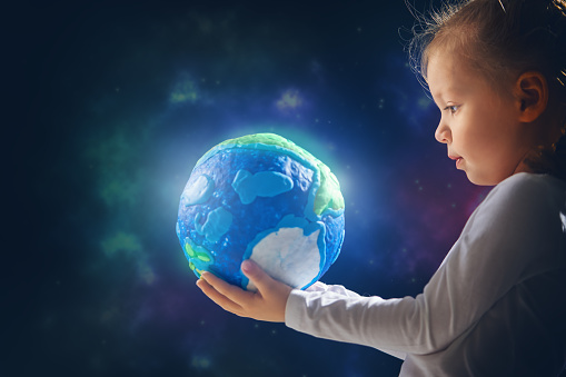 Child with globe. Happy Earth day.