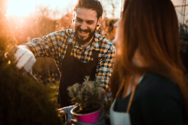 istock Young couple clipping hedge 1140353760