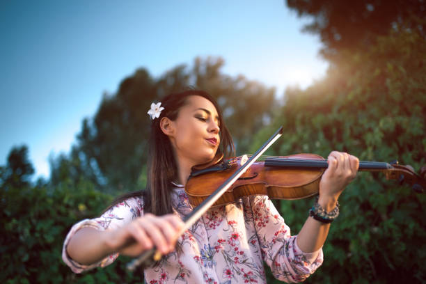 istock Girl violinist in nature 1140353789
