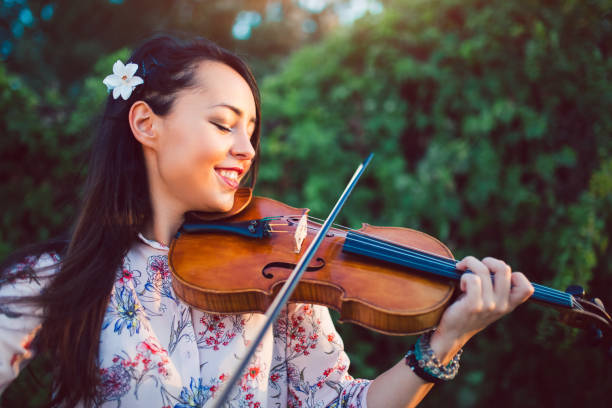 istock Girl violinist in nature 1140353847