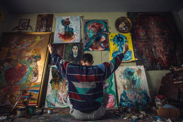 istock Painter sitting on the floor in home studio 1140358238
