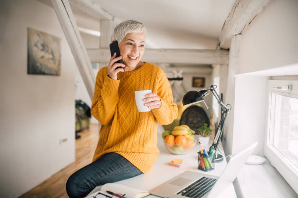 istock Woman using phone over a cup of coffee 1140358886