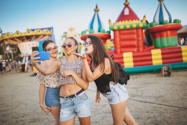 istock Girls taking selfies by inflatable castle 1140361123