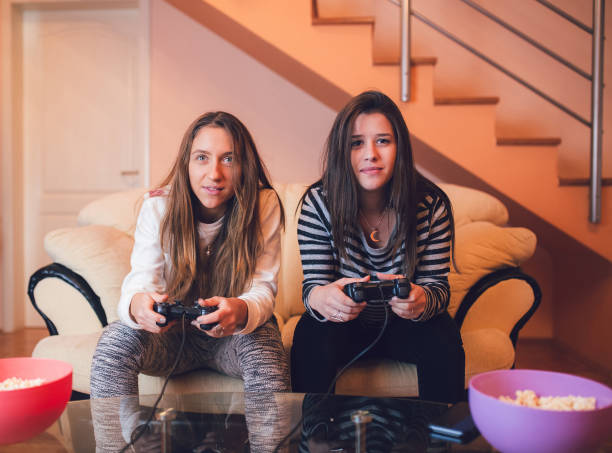 istock Girls playing video games 1140363180