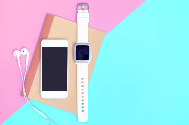 istock Empty mobile phone with smartwatch gadgets on blue pink 1140363209