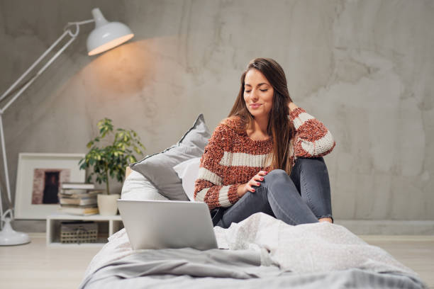 istock Woman using laptop in bedroom. 1140364346