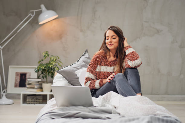istock Woman using laptop in bedroom. 1140364573