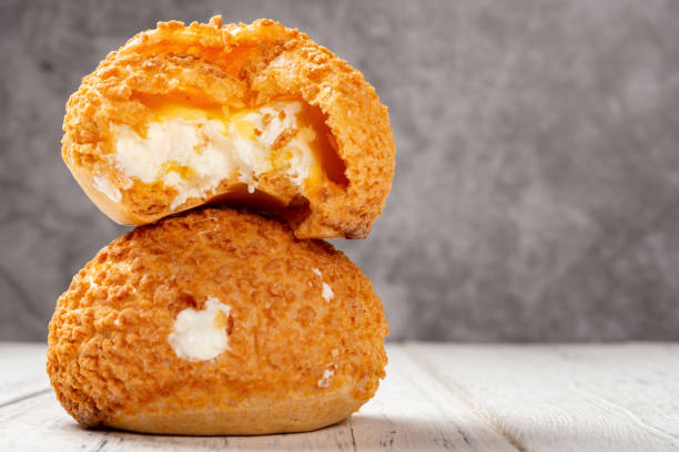 istock two pieces sweet puffs and one with a bite on a white wood table with copy space 1140364994