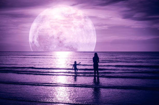 Super moon. Colorful sky with cloud and bright full moon over seascape.