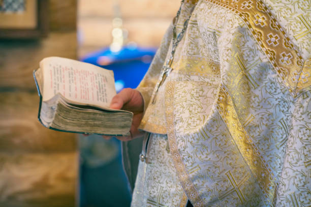 istock Book is in the hands of a priest 1140365148