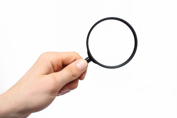 istock Male hand with a magnifying glass on a white background 1140366693