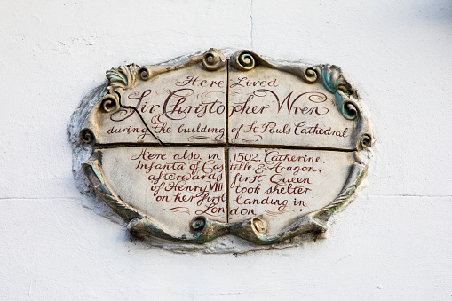 London, UK - April 1st 2019: Plaque on a little house along Bankside, noting that famous architect Sir Christopher Wren and Catherine of Aragon once lived there. This plaque is very curious as neither person actually lived there.