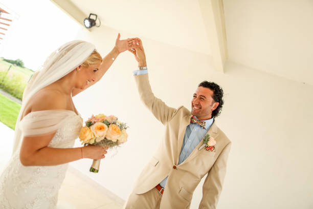 istock Beautiful wedding couple posing in front of white wall 1140368853
