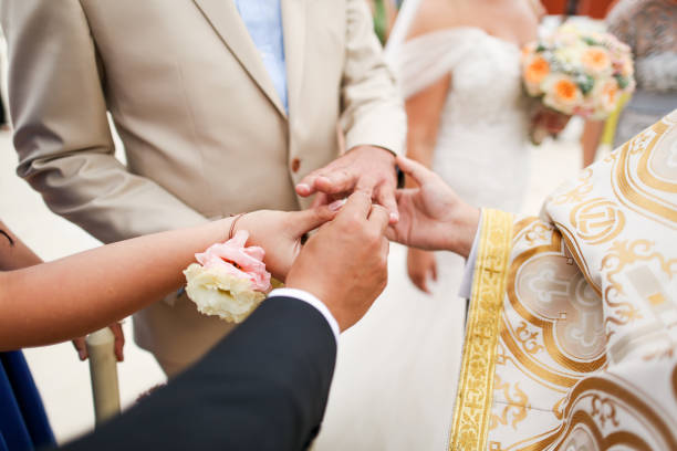 istock godfather fixing ring on grooms finger 1140369459