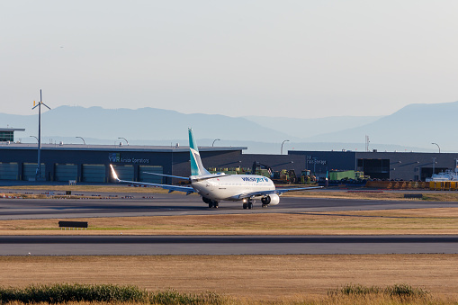 Vancouver, Canada - Circa 2018 : Westjet Boeing 737 passenger aircraft landing at Vancouver International Airport. C-GJLS