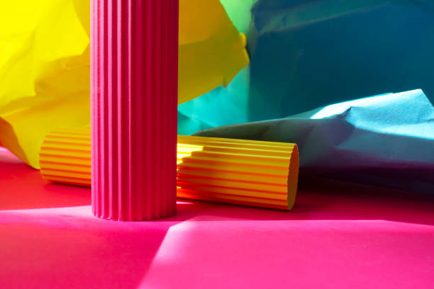 istock Wrinkled blue,yellow and green papers on pink background 1140371801