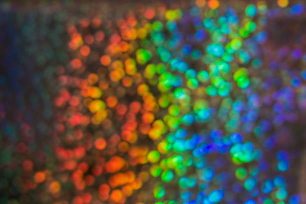 istock Multicolored background with many lights in blur. Glitter of sequins from the sun's rays. 1140373103