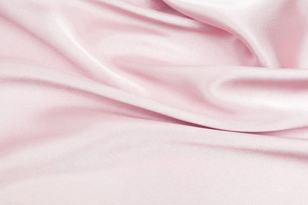istock Charming smooth satin and silk pink fabric for backgrounds. Elegant abstract upholstery use for holidays 1140373166