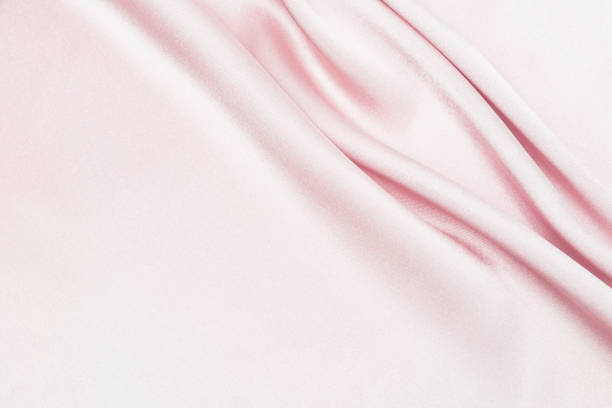 istock Charming smooth satin and silk pink fabric for backgrounds. Elegant abstract upholstery use for holidays 1140373185