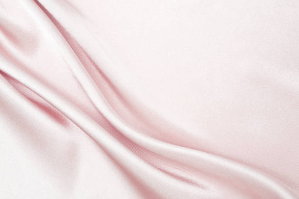 istock Charming smooth satin and silk pink fabric for backgrounds. Elegant abstract upholstery use for holidays 1140373201