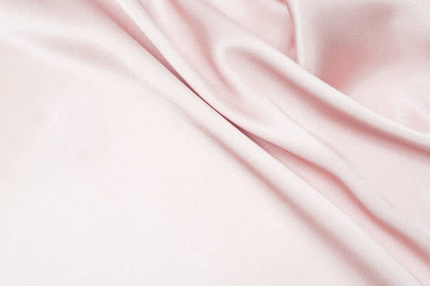 istock Charming smooth satin and silk pink fabric for backgrounds. Elegant abstract upholstery use for holidays 1140373234