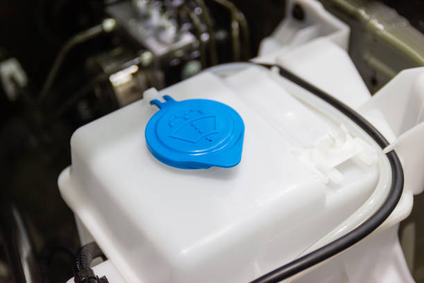 closeup new windshield washer water tank in the car engine