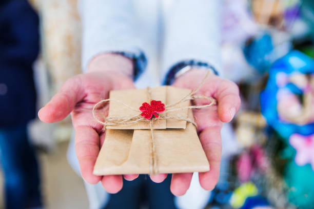 Young female hands holding gift