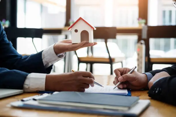 Photo of Real estate broker explain contract investment before signing a contract housing estate in office. contract and agreement concept.