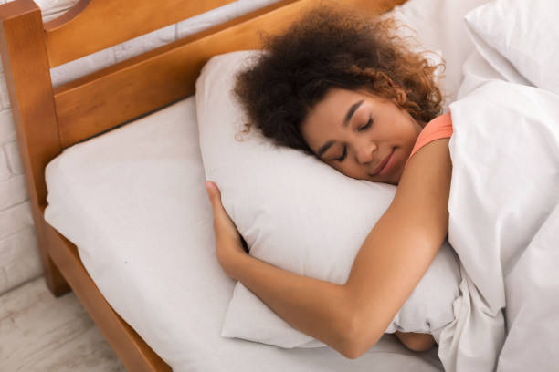 istock Relaxed woman sleeping on bed at home 1140376449