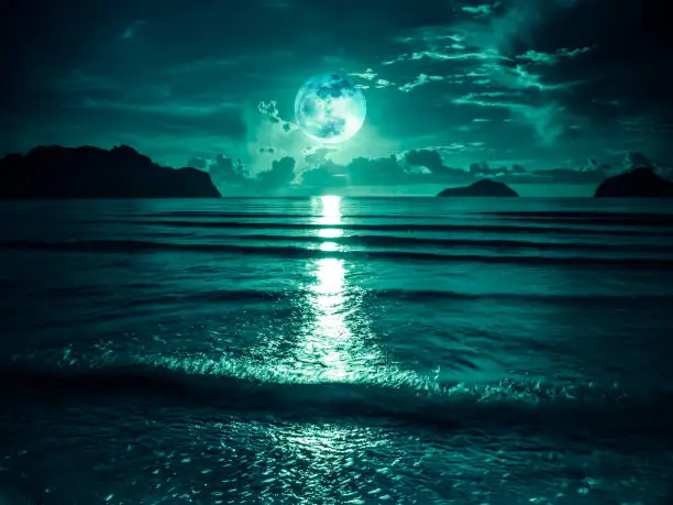 Photo of Super moon. Colorful sky with bright full moon over seascape. Serenity nature background, outdoor at gloaming.