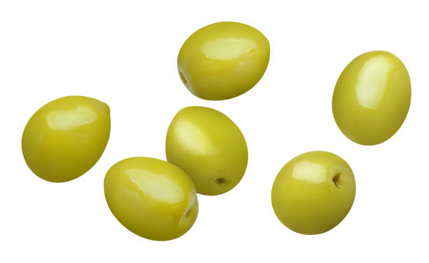 Olives on white Flying green olives, isolated on white background green olive fruit stock pictures, royalty-free photos & images