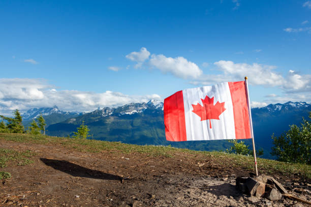 istock Canada Flag With Mountains in the background 1140377739