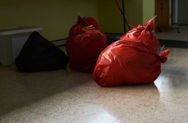 Red and black palstic garbage bags on the floor in the hospital