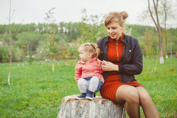 girl sitting on a stump - ticket ticket stub park fun imagens e fotografias de stock