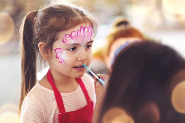 istock Brother and sister having a butterfly paint face 1140384821