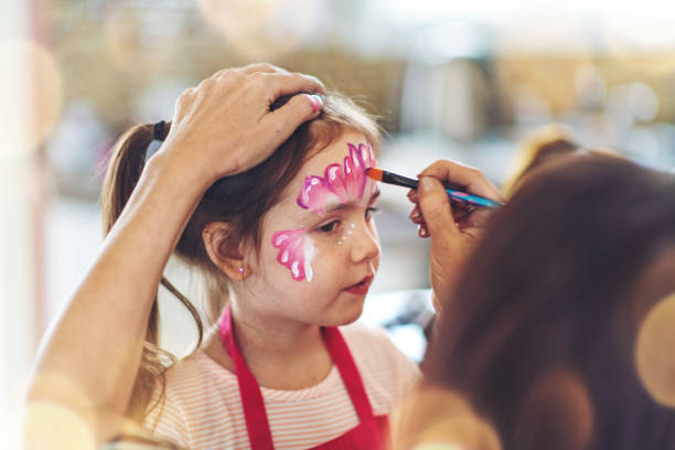 istock Brother and sister having a butterfly paint face 1140384822