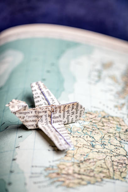 istock Origami travel concepts: Airplane flying on map 1140384865