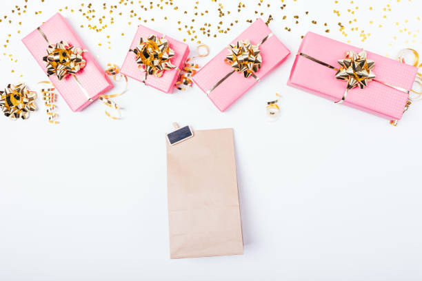 istock Paper bag next to festive pink gift boxes 1140384943