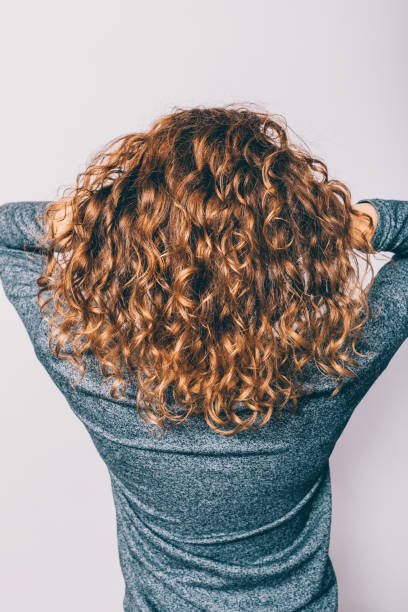 istock Woman's head with curly brown hair 1140385033