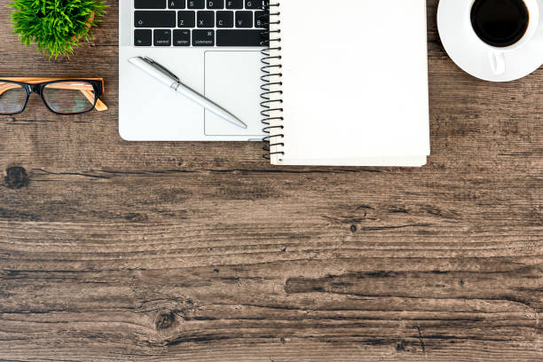 istock Brown wood office desk table and equipment for working in top view and copy space. 1140385105
