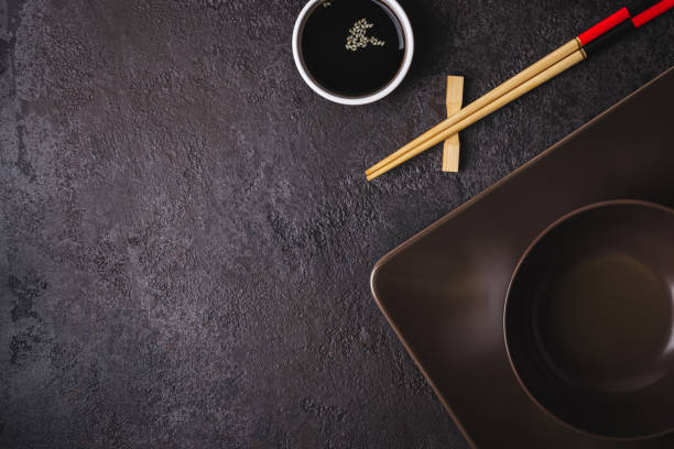istock Brown bowls, soy sauce and bamboo chopsticks. Asian table setting 1140385127