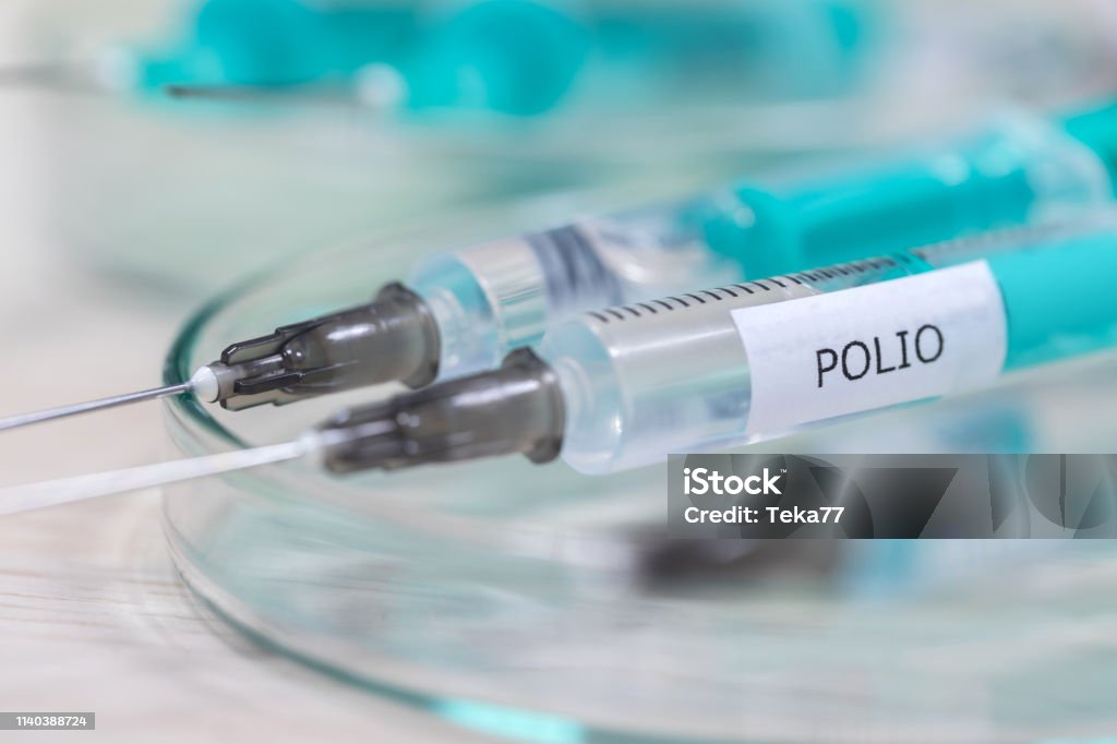 polio vaccination syringe background Polio Vaccine Stock Photo