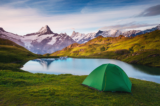 Alpine valley glowing by sunlight. Popular tourist attraction. Dramatic and picturesque scene. Location place Bachalpsee in Swiss alps, Grindelwald, Bernese Oberland, Europe. Beauty world.