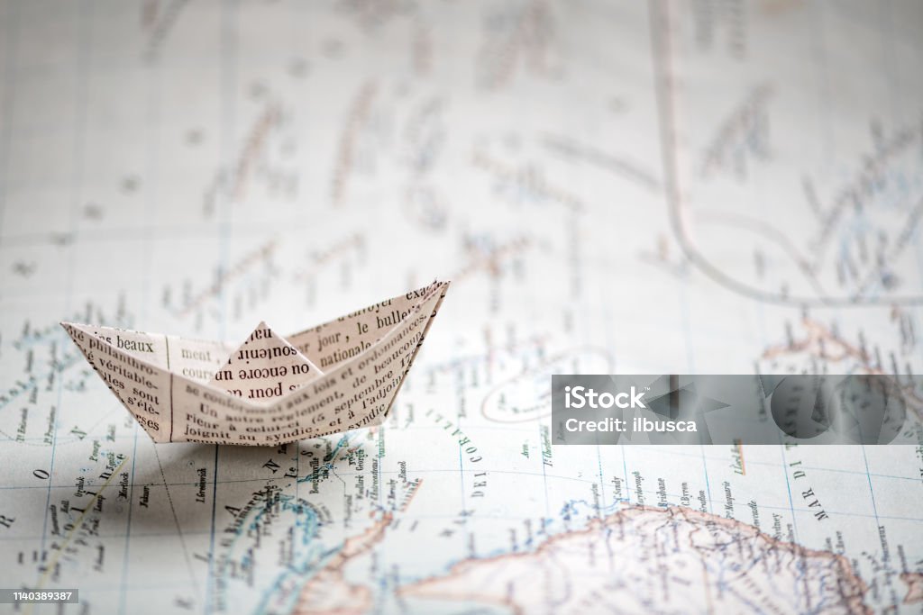 Origami travel concepts: Ship on map Book Stock Photo