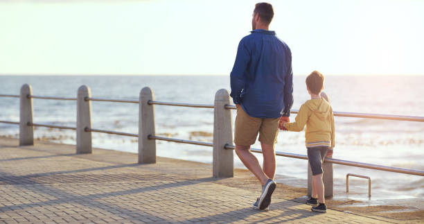 istock Taking a stroll on the bach with my little man 1140390371