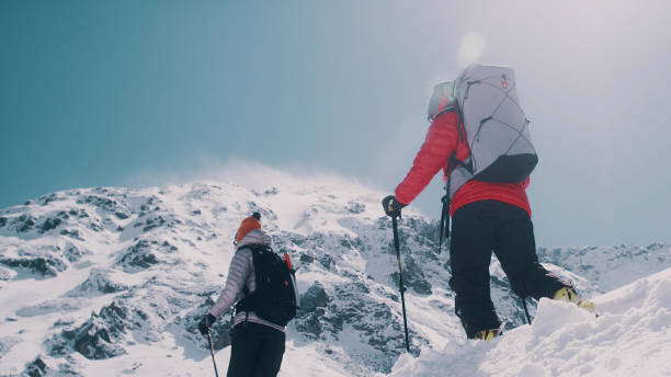 istock Winter mountain adventure. Young couple on a trail 1140390784